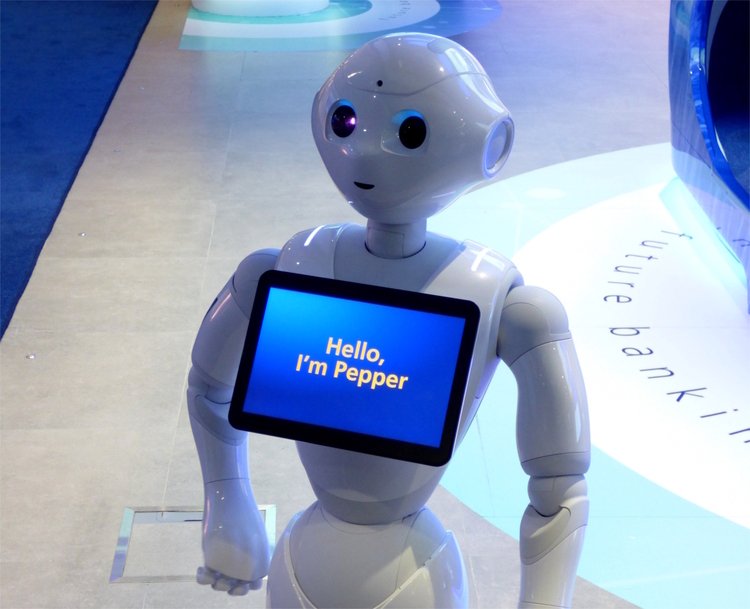 A white, humanoid robot with a screen on the chest