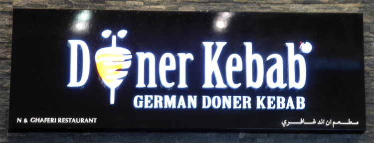 A restaurant sign reading 'Döner Kebab - German Doner Kebab'
