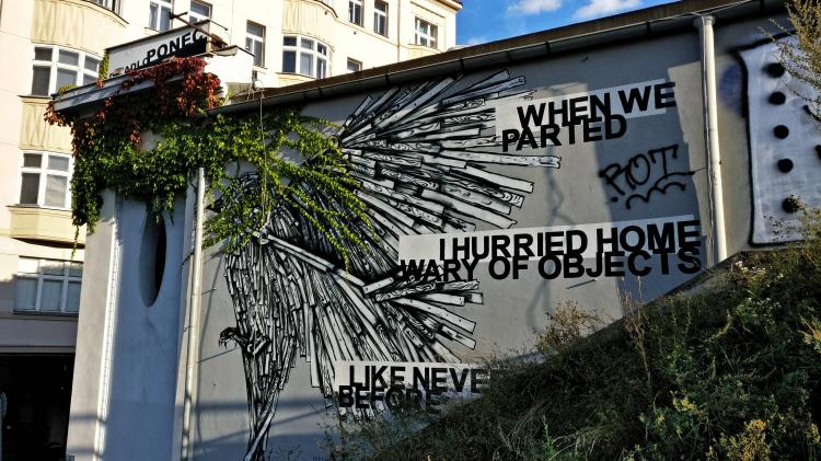 A black-and-white street-art mural showing a bird mid-flight next to the words 'when we parted / I hurried home wary of objects / like never before' in bold black text