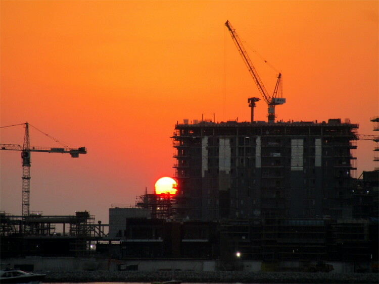 The sun setting over a large construction site