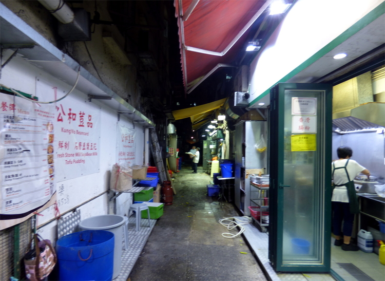A view into a narrow alley with what appears to be a kitchen to one side