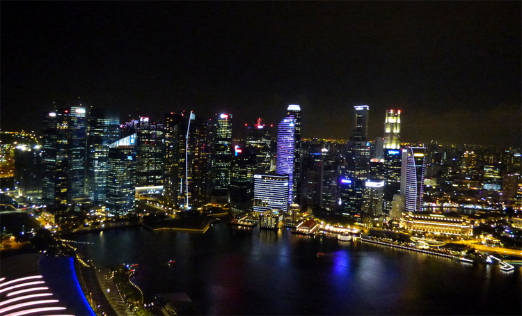 The skyline of Singapore curving around the waterfront at night