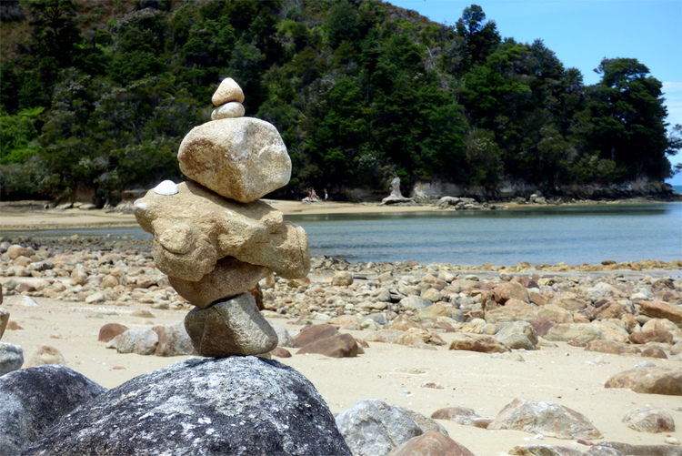 Carefully balanced rocks stacked on top of each other on a beach