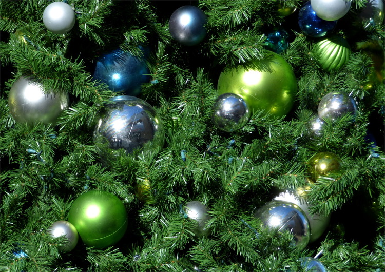 Close-up of silver and green Christmas ornaments in a tree