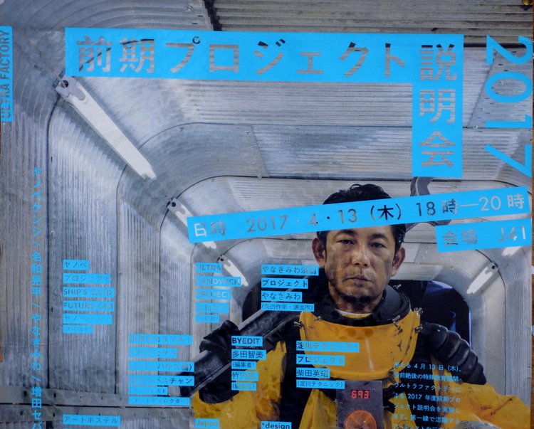 Close-up of a poster showing a man in an orange spacesuit walking through a corridor with blue Japanese text on top