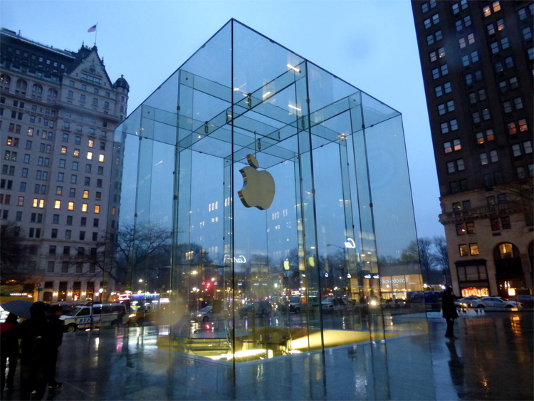 A cubic glass construction on a small square with the Apple-logo prominently displayed inside