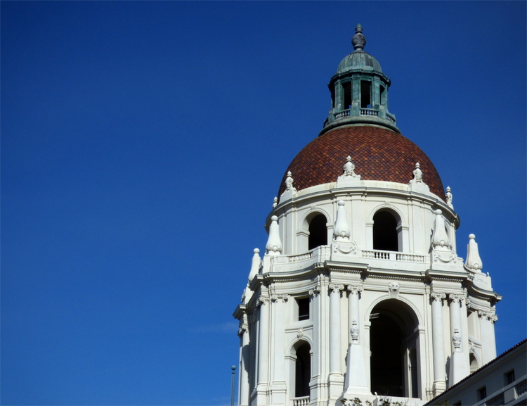 An elaborate white-and-red, renaissance-style domed roof against a clear blue sky