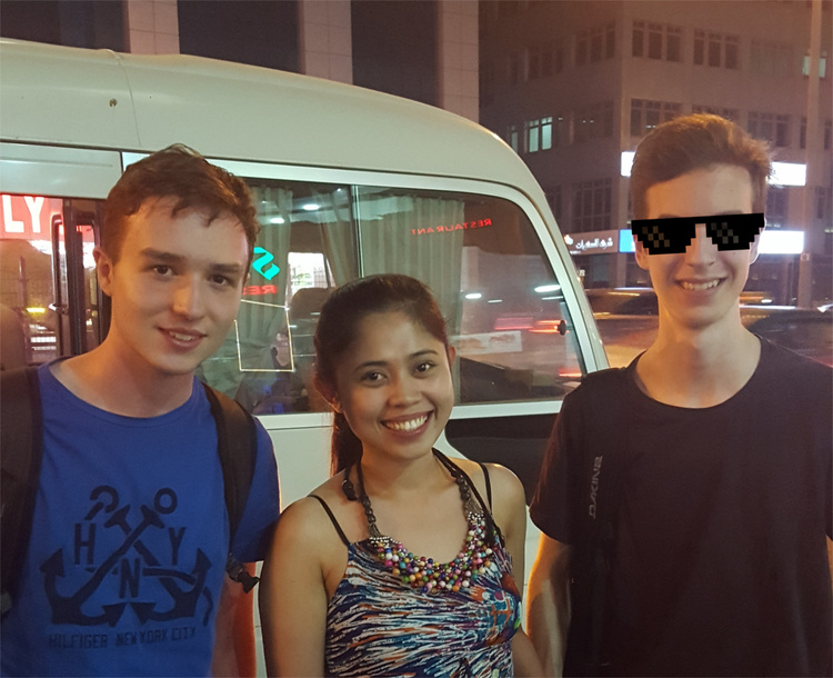 Group picture showing Jan, Juanie and Nils in front of a van, Nils having pixel-art sunglasses superimposed on his face