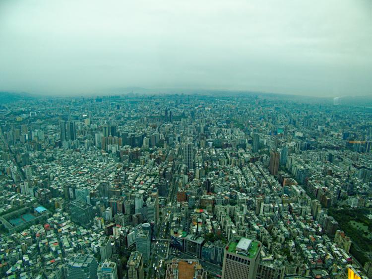 A sprawling city landscape seen from above, stretching out past the horizon