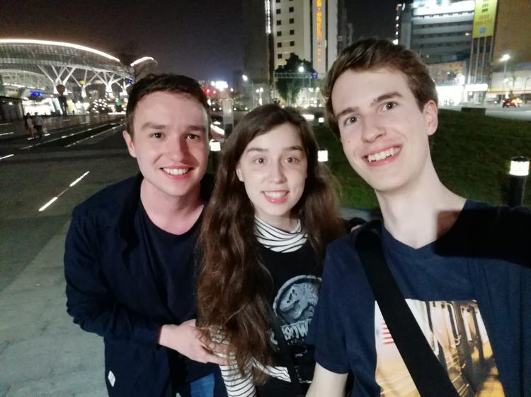Nighttime selfie showing Jan, Alex and Nils standing on the side of a road