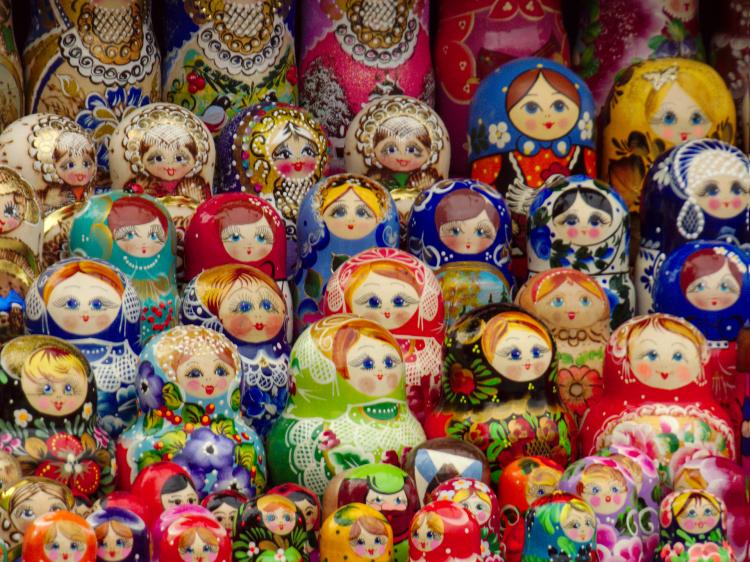 A display stand showing many Matryoshka dolls in different styles and sizes